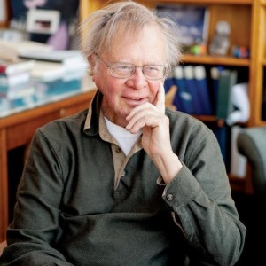 Climate change expert Wally Broecker smiling in study full of books