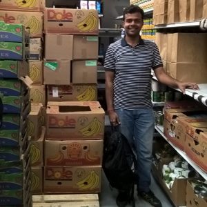 Student standing in food bank pantry