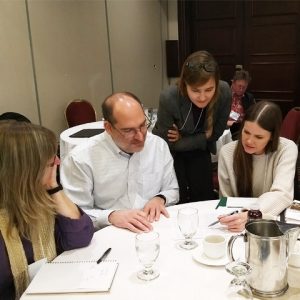 Working group discusses paper around table