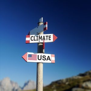 Road signs with Climate and USA pointing different directions