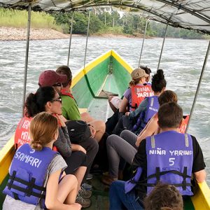 Group of professors ride boat across river