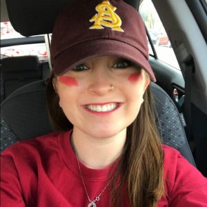 Sustainability student Zoe Stein smiles, wearing an ASU baseball cap