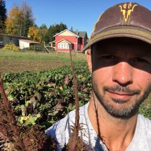 ASU student Adam Gabriele poses on a farm