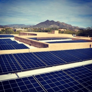 Solar panels on building with desert mountains in background