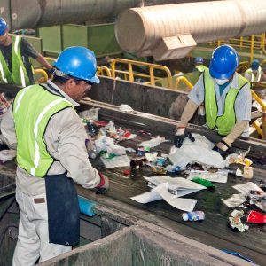Workers at a recycling facility sorting waste
