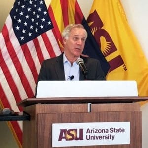 Gary Hirshberg at podium in from of US, Arizona and ASU flags.