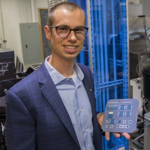 Zachary Holman holds solar cell