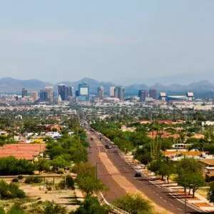 city with mountains in distance and street in foreground