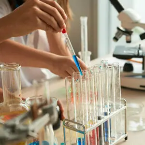 Two young women performing scientific experiment on a lab