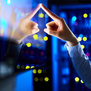Close-up of a hand touching a touch-screen with little lights illuminated in the background