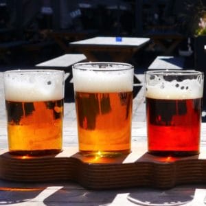 Three glasses of three different beers.
