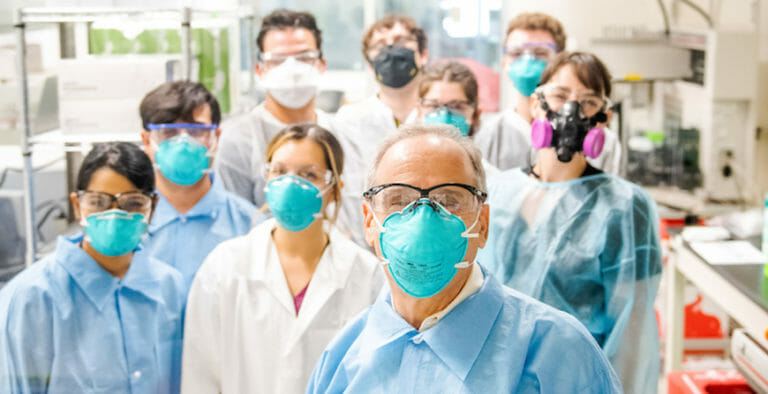 Joshua LaBaer and research team in laboratory, all wearing masks and lab coats.