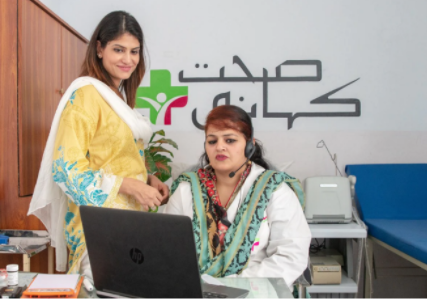 Dr. Saeed looking at a laptop screen with a call representative