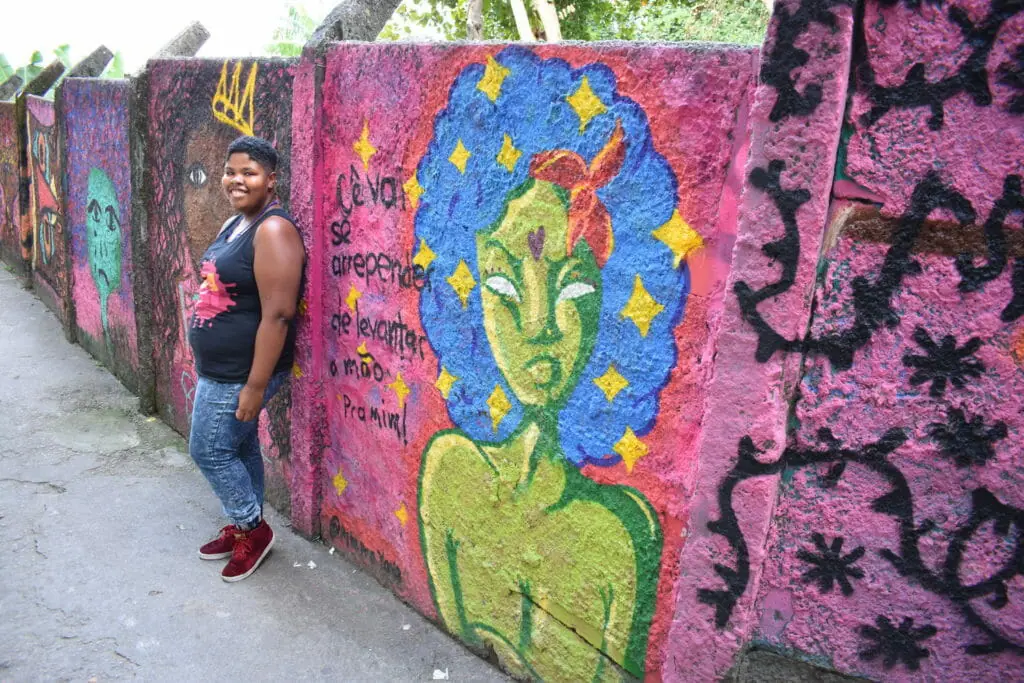 Yasmin posing with her graffiti wall art