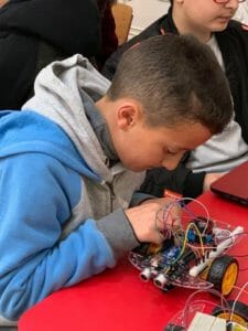 Boy working on robotics in tech class