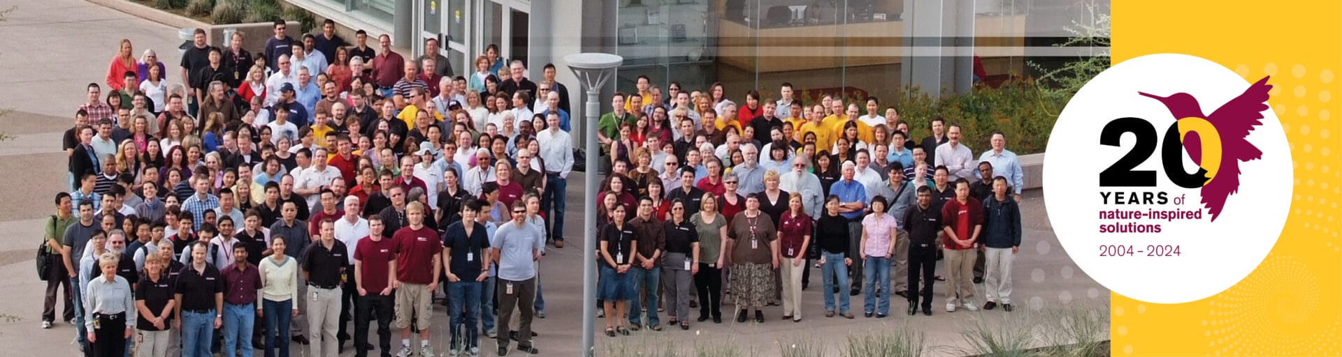 Group photo of Biodesign employees with 20th anniversary logo.